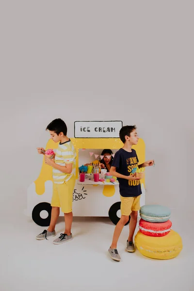 Lovely kids selling ice cream on ice cream truck stand