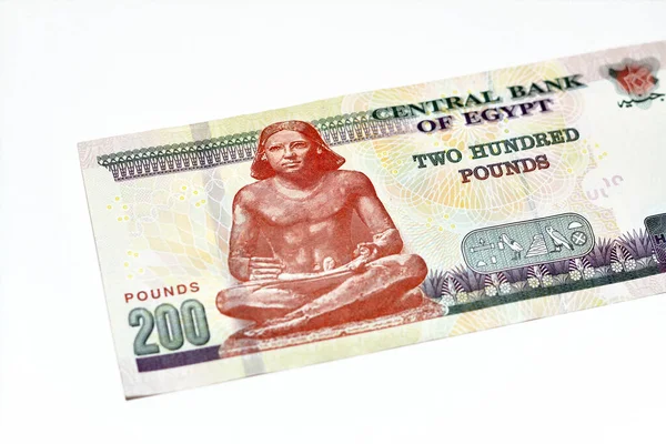 stock image Reverse side of 200 LE EGP two hundred Egyptian pounds cash money banknote series 2022 features the seated scribe of ancient Egypt, selective focus of Egyptian money isolated on white background