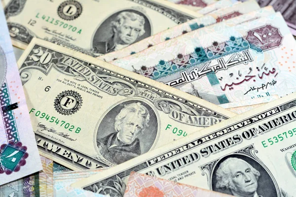 stock image Pile of Egyptian and American money currency banknotes of 1, 2 and 20 dollars and 10, 20, 100 and 200 EGP LE Egyptian pounds bills, American and Egyptian money banknote exchange rate, selective focus