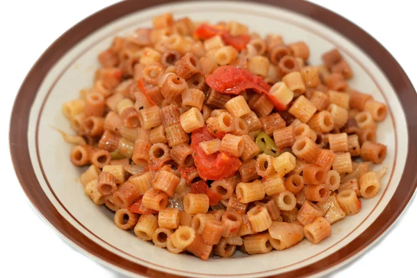 stock image tasty appetizing classic ring pasta macaroni with tomato sauce and pieces, garlic, onion, spices, oil and black and green pepper, selective focus of an Italian recipe done the Egyptian way