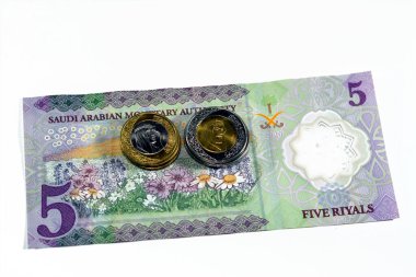 Yeni polimerin ters tarafı 5 SAR 5 Suudi Arabistan riyalleri nakit para banknot serisi 1441 AH 1 ve 2 riyalli bir çiçek tarlası beyaz, seçici odak üzerinde izole edilmiş bozuk paralar