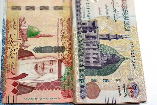 stock image One hundred Saudi Arabia riyals cash money banknote 100 SAR features king Salman and the prophet mosque with 200 LE EGP two hundred Egyptian pounds features Qani Bay mosque, money exchange rate