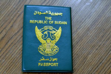 Ön kapağında yaldızlı bir şahin bulunan Sudan Cumhuriyeti pasaportu seyahat sırasında vize pulu almak için kullanılan Kuzey Sudan pasaport kimliğinin seçici odak noktası.