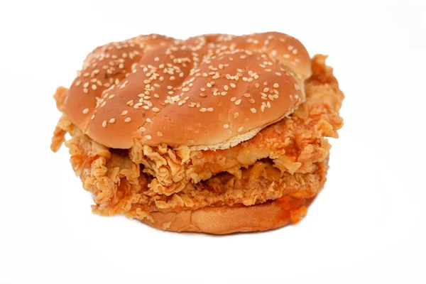 Stock image double breaded spicy chicken fried breast fillet topped with lettuce and mayonnaise in a toasted sesame seed bun, crispy and crunchy chicken strips sandwich, selective focus of junk food concept