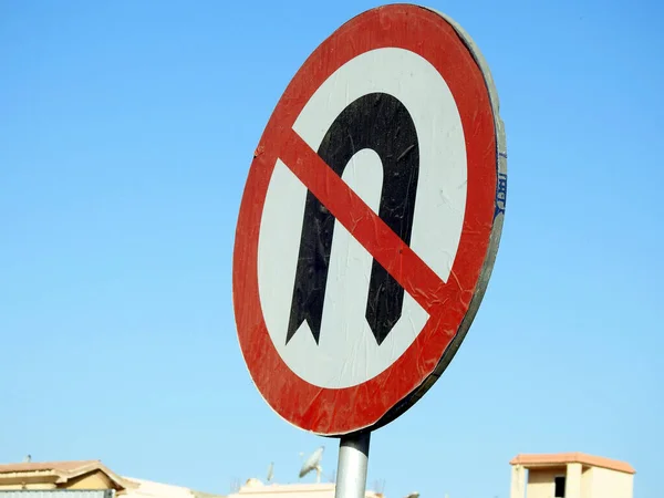 No U-turn sign, a regulatory sign posted at intersections to indicate the driver is not legally allowed to make a U-turn (a turn in the road to go the opposite direction), selective focus