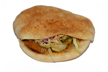 Stuffed Falafel sandwich, a very popular and traditional Egyptian food, a warm pita bread stuffed with crispy hot falafel balls with cool and crunchy diced tomatoes, cucumbers, onions and tahini