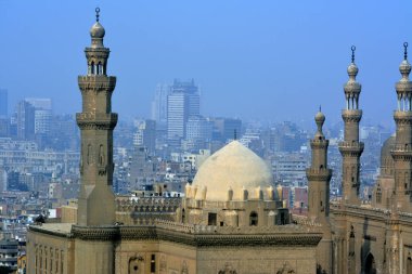 Cairo, Egypt, January 7 2023: Sultan Hassan and Al Rifa'i Mosques in old Cairo city Citadel square, very famous Islamic mosques in Egypt and very close to each other, selective focus and foggy view