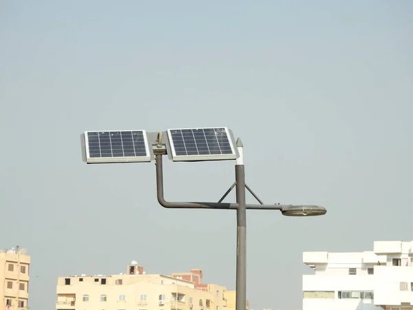 lamppost powered by clean energy of solar cells panel, or photovoltaic cell, an electronic device that converts the energy of light directly into electricity by photovoltaic effect, selective focus