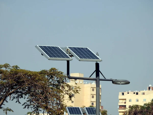 lamppost powered by clean energy of solar cells panel, or photovoltaic cell, an electronic device that converts the energy of light directly into electricity by photovoltaic effect, selective focus