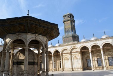 Ablution fountain and the clock tower in courtyard of The great mosque of Muhammad Ali Pasha or Alabaster mosque at the Citadel of Cairo, Salah El Din Castle, details of Mohamed Ali mosque courtyard