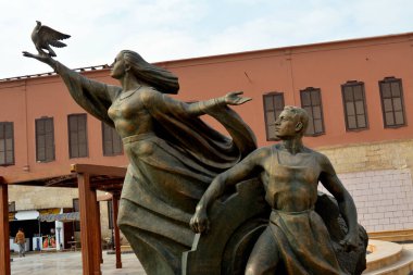 Cairo, Egypt, January 7 2023: old Egyptian statue of a lady flying a pigeon and a man from the Egyptian national military museum in Cairo citadel, official army museum, selective focus