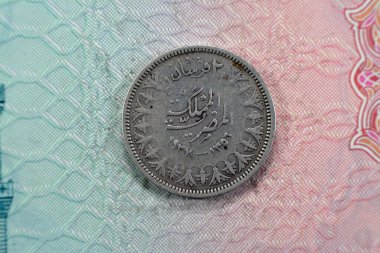 Ancient round old two 2 piasters coin at the era of king Farouk I features value and kingdom of Egypt on a side and a bust of King Farouk the 1st on the other side, vintage retro coin 1937 AD 1356 AH