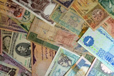 various old cash money banknotes from different countries of the world, stack of multiple currencies, pile of vintage retro bills of different origins with profiles of country leaders, ancient money