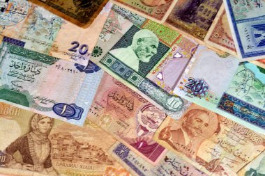 various old cash money banknotes from different countries of the world, stack of multiple currencies, pile of vintage retro bills of different origins with profiles of country leaders, ancient money