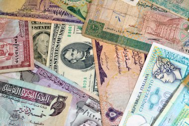 various old cash money banknotes from different countries of the world, stack of multiple currencies, pile of vintage retro bills of different origins with profiles of country leaders, ancient money