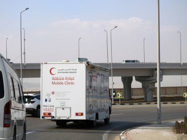Cairo, Egypt, January 8 2023: A mobile medical clinic vehicle of the Egyptian red crescent that gives medical services in Cairo, patient examination and medical help aid, a medical truck on the road