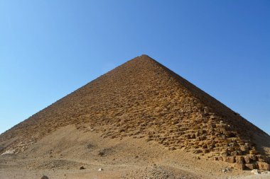 The red north pyramid of Dahshur of king Sneferu, named for the rusty reddish hue of its red limestone stones, also called the bat pyramid, it contains burial chambers, vintage retro ancient Egypt