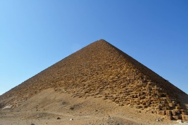 The red north pyramid of Dahshur of king Sneferu, named for the rusty reddish hue of its red limestone stones, also called the bat pyramid, it contains burial chambers, vintage retro ancient Egypt