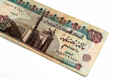 One hundred Egyptian pounds 100 EGP LE series 2004 features Sultan Hassan mosque on obverse side and Sphinx of Giza Egypt on the reverse, selective focus of old Egyptian banknote money bill