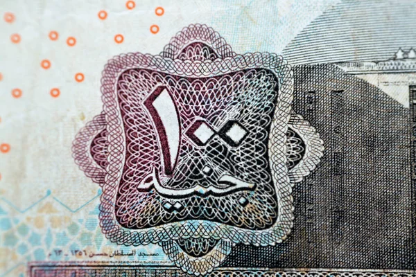 Close up of One hundred Egyptian pounds 100 EGP LE 2004 features Sultan Hassan mosque on obverse side and Sphinx of Giza Egypt on the reverse, selective focus of old Egyptian banknote money bill