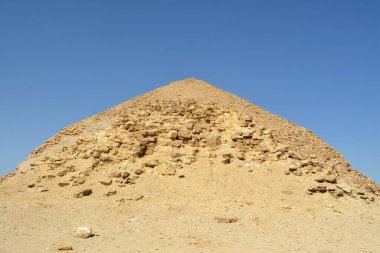 The satellite and the bent pyramids, Satellite one is located 55 meters south to the bent pyramid of king Sneferu, 26 meters in height and 52.80 meters in length and the bent's height is 104 meters