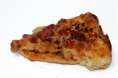 Italian pizza with pieces of pastrami, meat, beef and salami, with mozzarella cheese and peppers, baked pizza with ketchup ready to be served as a lunch and snack, fast unhealthy food concept