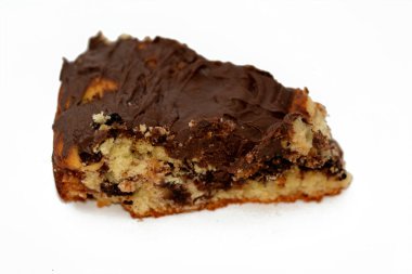 baked dough covered with chocolate and stuffed with pieces of chocolate, biscuit, cake, caramel and brownies, ready to be served, selective focus of a chocolate sweet pastry cake