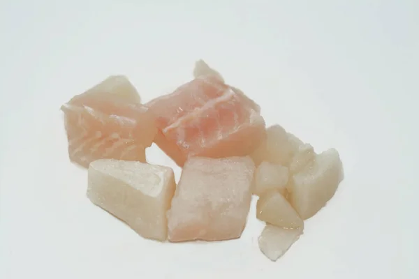 Fresh cut pieces of frozen calamari and fish fillet ready to be cooked in a seafood meal soup or in sea food salad traditional meal, fresh pieces of calamary and fillets isolated, selective focus