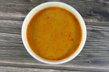 Hot soup meal of various fresh seafood marine crabs, shrimps, clams, mussels, gandofli, oysters, crab sticks, calamari, squid and fish fillet cooked on hot steam merged in water, milk, lime and spices