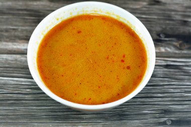 Hot soup meal of various fresh seafood marine crabs, shrimps, clams, mussels, gandofli, oysters, crab sticks, calamari, squid and fish fillet cooked on hot steam merged in water, milk, lime and spices