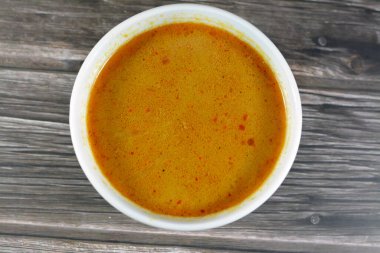 Hot soup meal of various fresh seafood marine crabs, shrimps, clams, mussels, gandofli, oysters, crab sticks, calamari, squid and fish fillet cooked on hot steam merged in water, milk, lime and spices