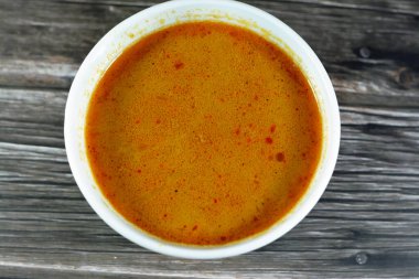 Hot soup meal of various fresh seafood marine crabs, shrimps, clams, mussels, gandofli, oysters, crab sticks, calamari, squid and fish fillet cooked on hot steam merged in water, milk, lime and spices