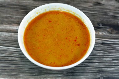 Hot soup meal of various fresh seafood marine crabs, shrimps, clams, mussels, gandofli, oysters, crab sticks, calamari, squid and fish fillet cooked on hot steam merged in water, milk, lime and spices