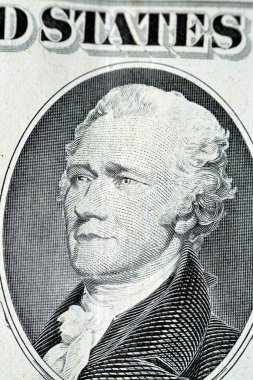 The portrait of Alexander Hamilton, who served as the first U.S. Secretary of the Treasury from the obverse side of old 10 $ ten American dollars bill banknote series 1988, old vintage American money