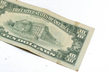The reverse side of old 10 $ ten American dollars bill banknote series 1988 features  the U.S. Treasury Building, selective focus of vintage retro old American money note isolated on white background