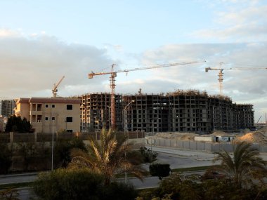 Giza, Egypt, February 4 2023: A construction site of new high rise in Egypt by Orascom construction Zed city Sheikh Zayed, new real estate Egyptian projects and new residential towers, selective focus
