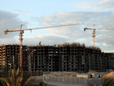 Giza, Egypt, February 4 2023: A construction site of new high rise in Egypt by Orascom construction Zed city Sheikh Zayed, new real estate Egyptian projects and new residential towers, selective focus