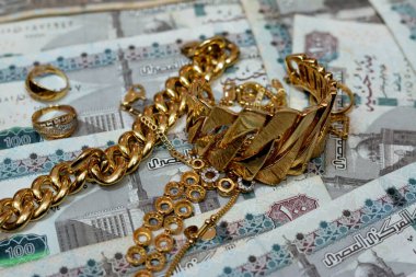 Jewellery or jewelry with EGP LE Egyptian pounds cash money banknotes, brooches, rings, necklaces, earrings, pendants, bracelets, chain and cufflinks, Gold price in Egyptian EGP LE pounds concept