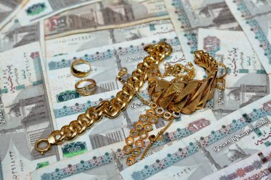 Jewellery or jewelry with EGP LE Egyptian pounds cash money banknotes, brooches, rings, necklaces, earrings, pendants, bracelets, chain and cufflinks, Gold price in Egyptian EGP LE pounds concept