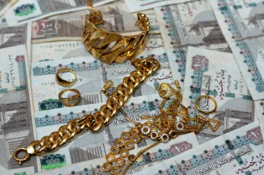 Jewellery or jewelry with EGP LE Egyptian pounds cash money banknotes, brooches, rings, necklaces, earrings, pendants, bracelets, chain and cufflinks, Gold price in Egyptian EGP LE pounds concept