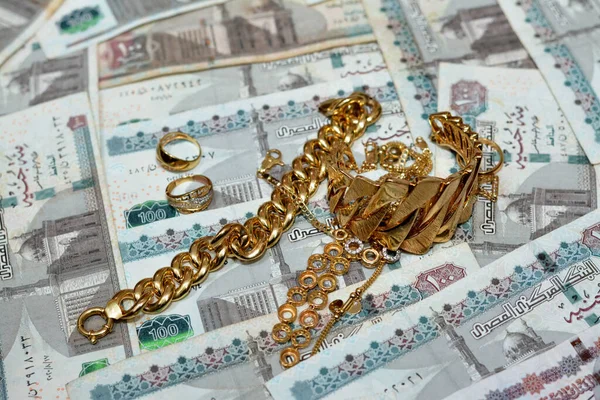 Jewellery or jewelry with EGP LE Egyptian pounds cash money banknotes, brooches, rings, necklaces, earrings, pendants, bracelets, chain and cufflinks, Gold price in Egyptian EGP LE pounds concept