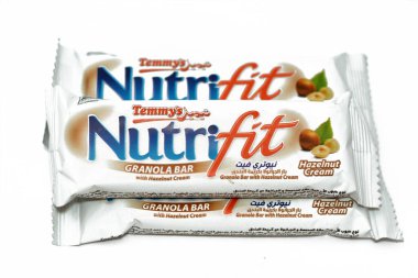 Cairo, Egypt, February 10 2023: Nutrifit granola bar with hazelnut cream, sweet sugary snack, sweetness and aromas of Apple Pie, selective focus of delicious candy of mixed granola and hazelnut