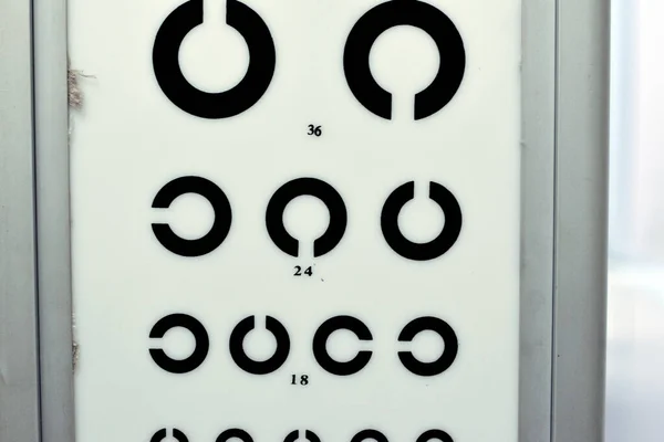 Landolt C broken ring optotypes or Japanese vision test in various sizes and orientations, an eye chart used for testing vision and visual acuity used by health care professionals, selective focus