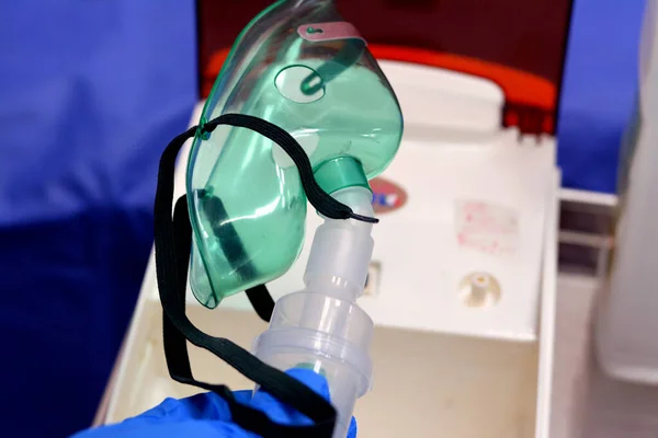 A nebulizer or nebuliser mask that is connected to oxygen cylinder or a drug delivery device used to administer medication in the form of a mist inhaled into the lungs used for emergency