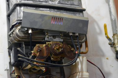 Cairo, Egypt, February 25 2023: A gas water heater is a tank that heats water from a gas-fired burner located at the bottom of the tank, uses the heat from burning a fuel (usually natural gas)