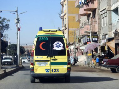 Giza, Egypt, January 26 2023: Ambulance on road responding for an emergency call of road accidents, Translation of Arabic text (ministry of health, Egyptian ambulance organization), selective focus