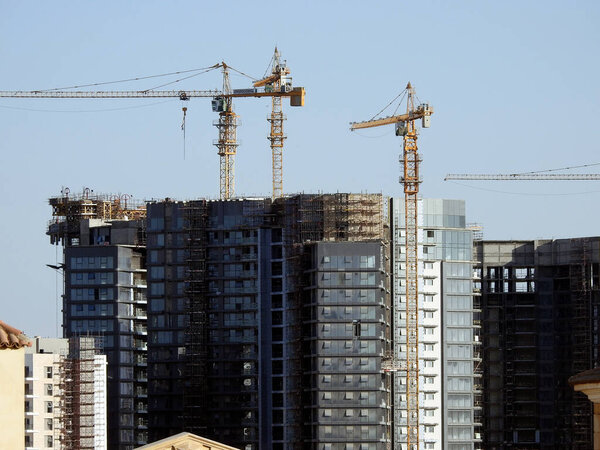 Giza, Egypt, March 10 2023: zed city By Orascom Construction company, buildings, high rise of new residential flats in Sheikh Zayed city with tower cranes and skyscrapers, selective focus