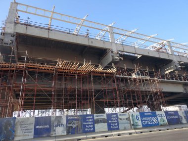 Cairo, Egypt, March 11 2023: Cairo monorail site that is under construction by Orascom company with the columns and the tracks in New Cairo city, rapid transit system, longest driver less monorail clipart