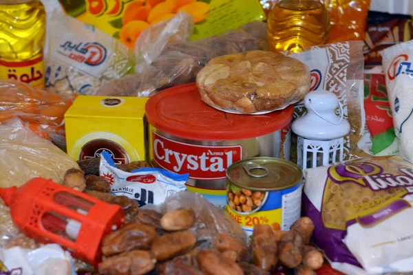 stock image Cairo, Egypt, March 12 2023: Essential and basic food supplies oil, ghee, sugar, lentil, fava beans, rice, macaroni, salt, tea and Ramadan month Yamish dates, coconut, apricot paste, raisins, peatnuts