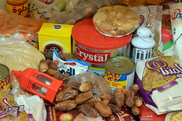 stock image Cairo, Egypt, March 12 2023: Essential and basic food supplies oil, ghee, sugar, lentil, fava beans, rice, macaroni, salt, tea and Ramadan month Yamish dates, coconut, apricot paste, raisins, peatnuts